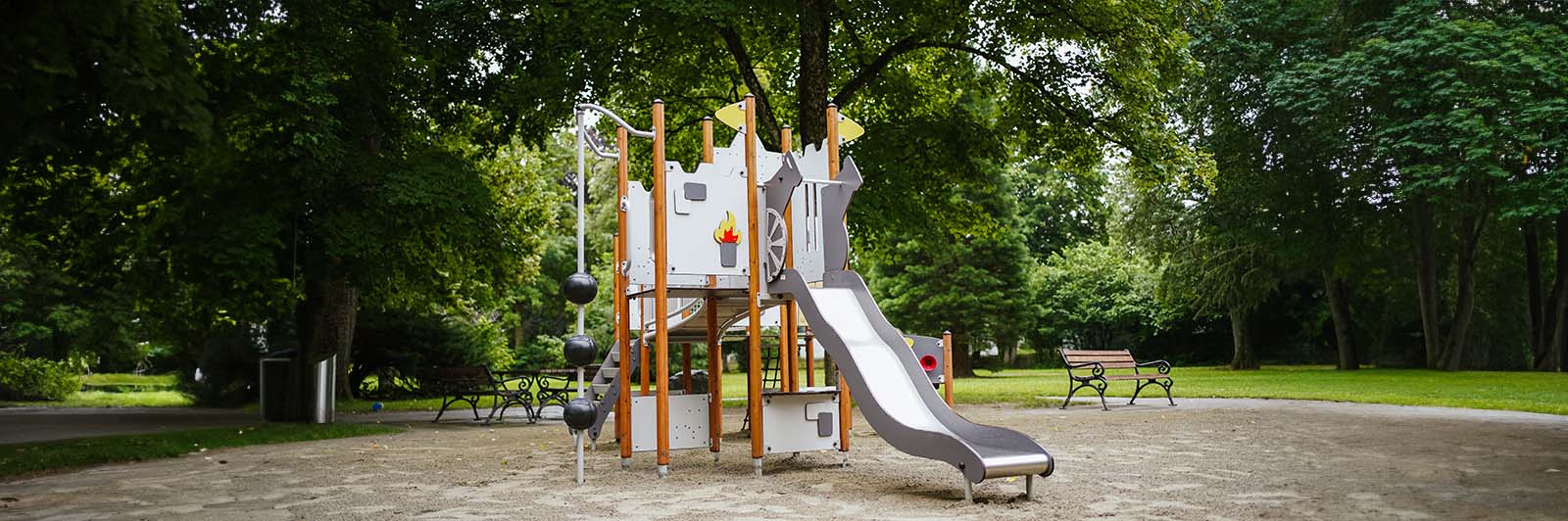 A small playground unit for small children shaped like a castle.